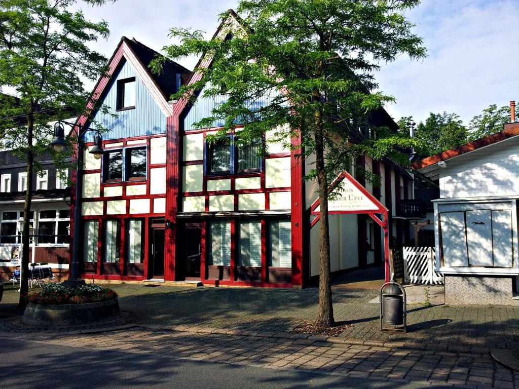 a building with a red and white building at Hotel an der Uffe in Bad Sachsa