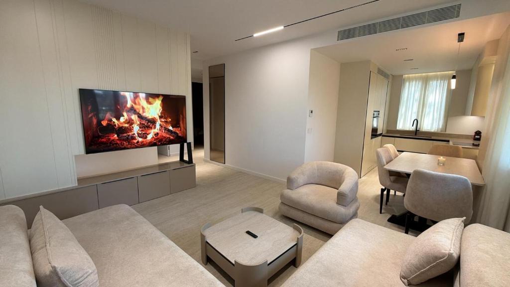 a living room with a couch and a tv on a wall at RETLAV LUXURY Apartment in San Donato Milanese