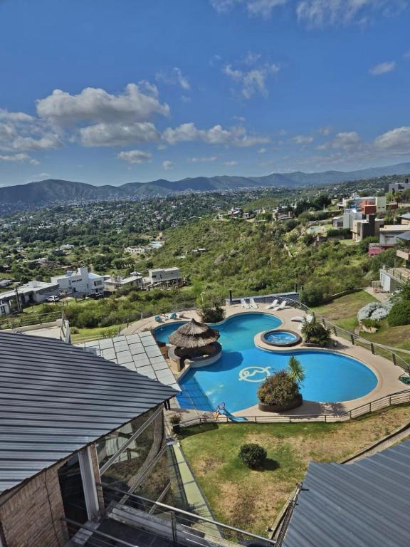 an aerial view of a swimming pool at a resort at ERNESTINA VILLAGE Resort Apart & suites in Villa Carlos Paz