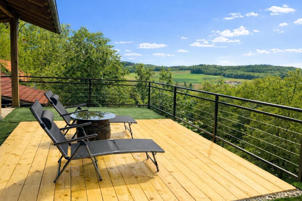 a patio with two chairs and a table on a deck at Papa Franks House in Ptuj