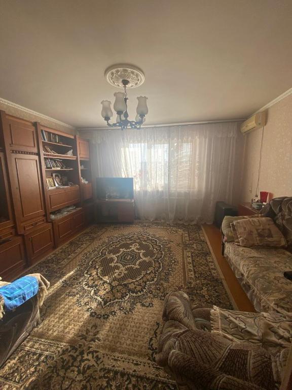 a living room with a couch and a rug at Апартаменты м Южне in Sychavka