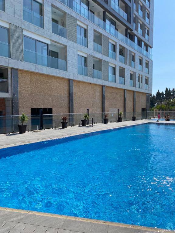 a large blue swimming pool in front of a building at Golden LUX in Bar