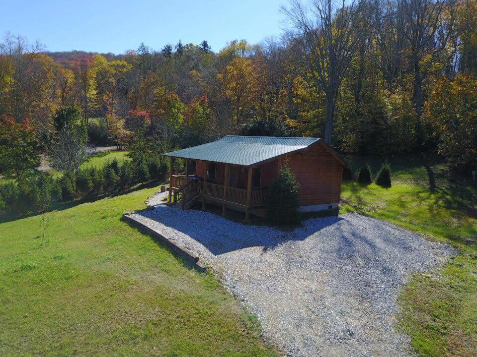 a small cabin on a hill in a field at Little Elk Cabin in Banner Elk