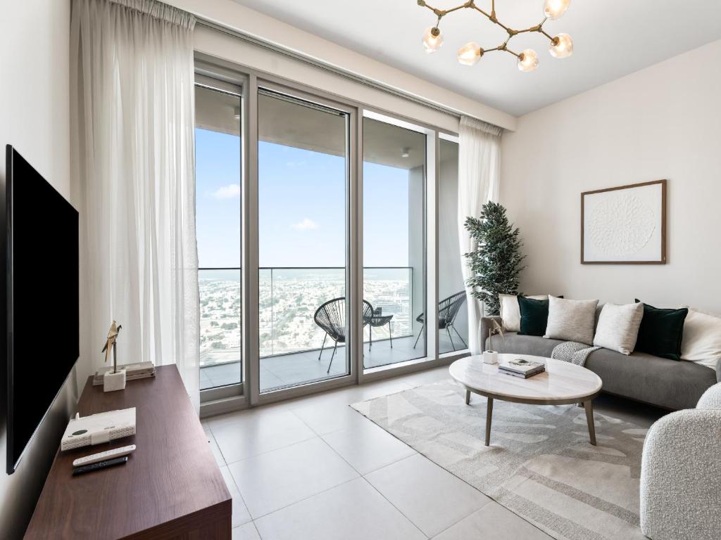 a living room with a couch and a table at Exquisite 2BDR Retreat In Forte-33 in Dubai