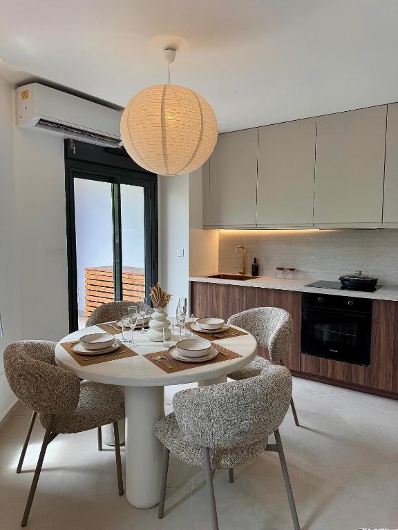 a kitchen with a table and chairs in a kitchen at Ambre du lagon in Saint-Pierre
