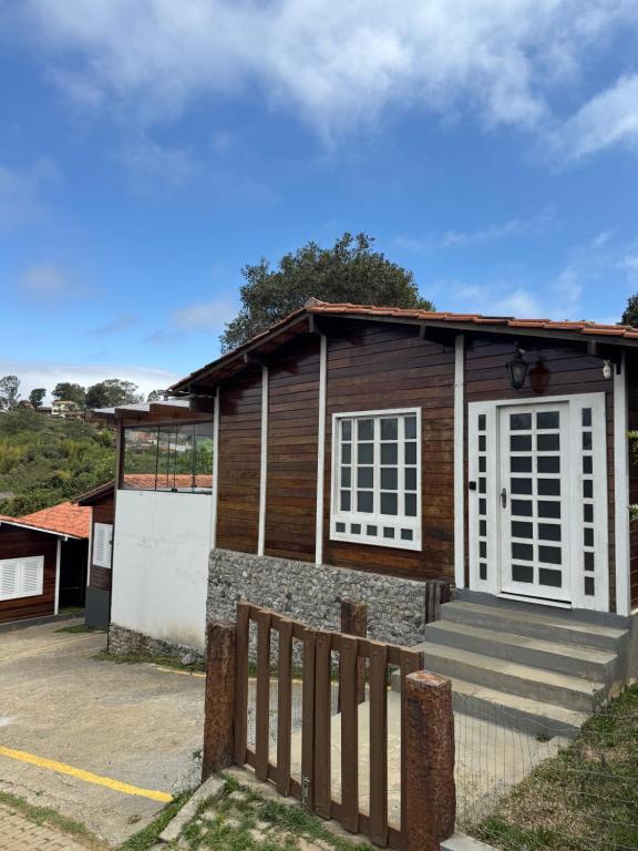 a small house with a fence in front of it at CASA DA MATA - LAVRAS NOVAS in Lavras Novas