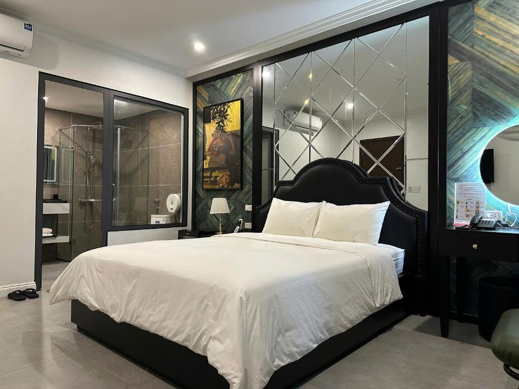 a bedroom with a large bed with white sheets at Nhật Tân Hotel Vĩnh Ngọc II- Đông Anh in Dong Anh