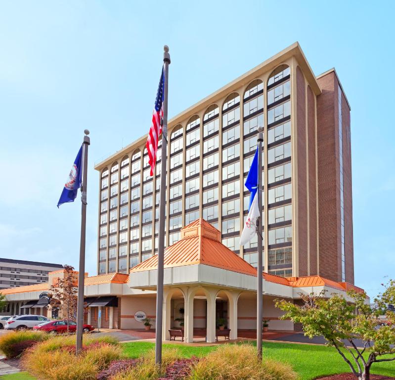 a hotel building with flags in front of it at Hotel Belvoir Springfield in Springfield