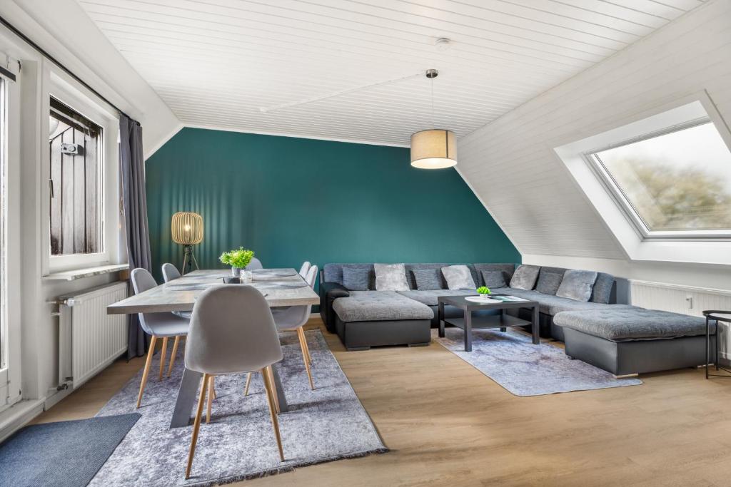 a living room with a couch and a table at Heide Ferienwohnung West Nr-4 in Schneverdingen