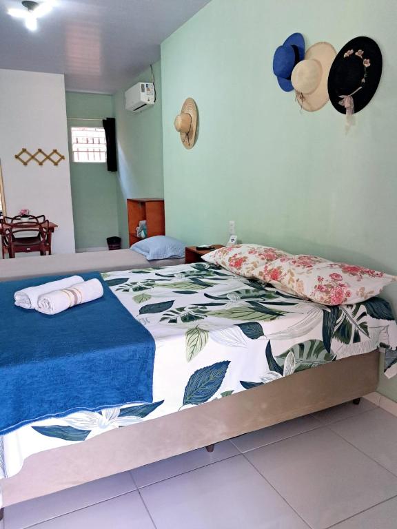 a bedroom with two beds with hats on the wall at Aguapé 4 in Barreirinhas