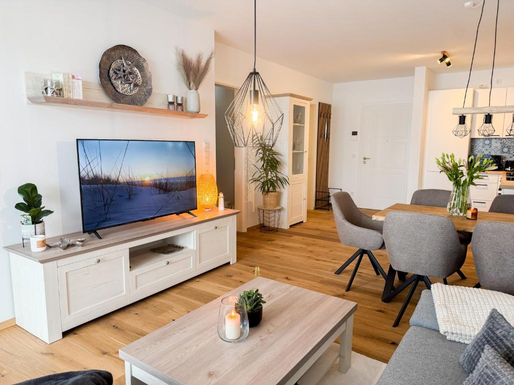 a living room with a flat screen tv at Ferienwohnung Seeschlösschen am Dümmer See in Lembruch