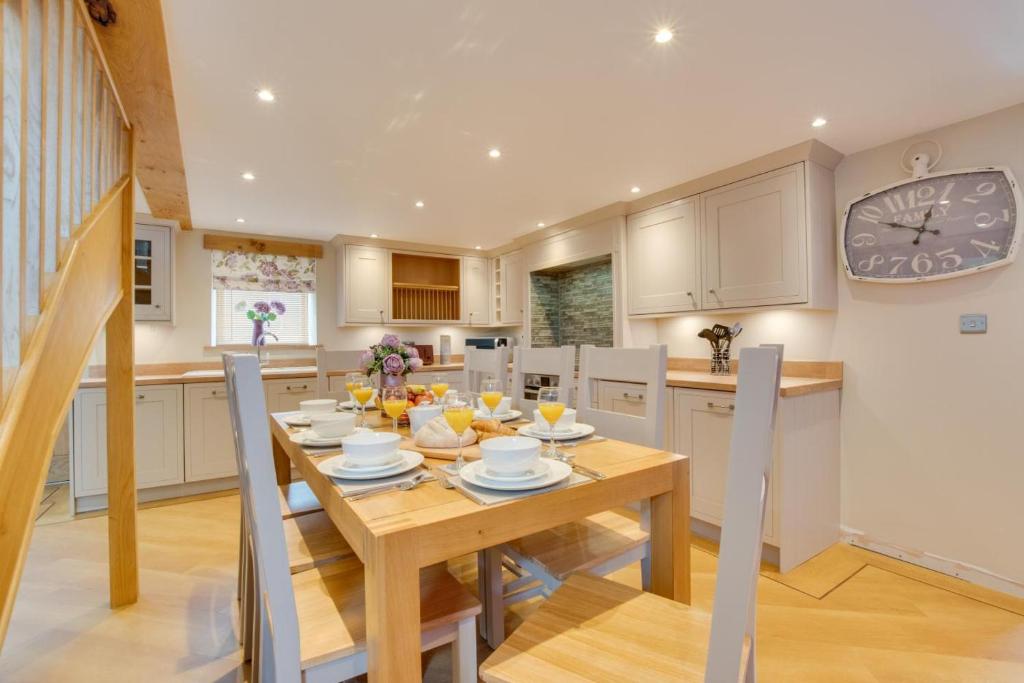 a kitchen with a table and a clock on the wall at 4 Bed in Bala oc-bow66 in Bala