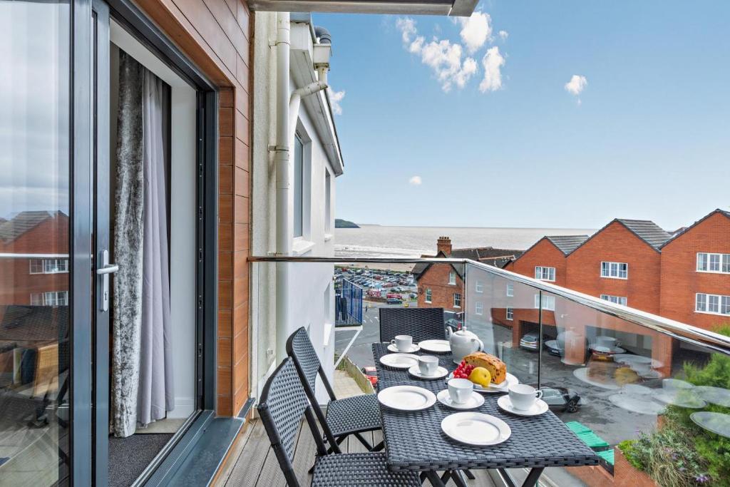 a balcony with a table with plates of food on it at 2 Bed in Woolacombe oc-m29811 in Woolacombe
