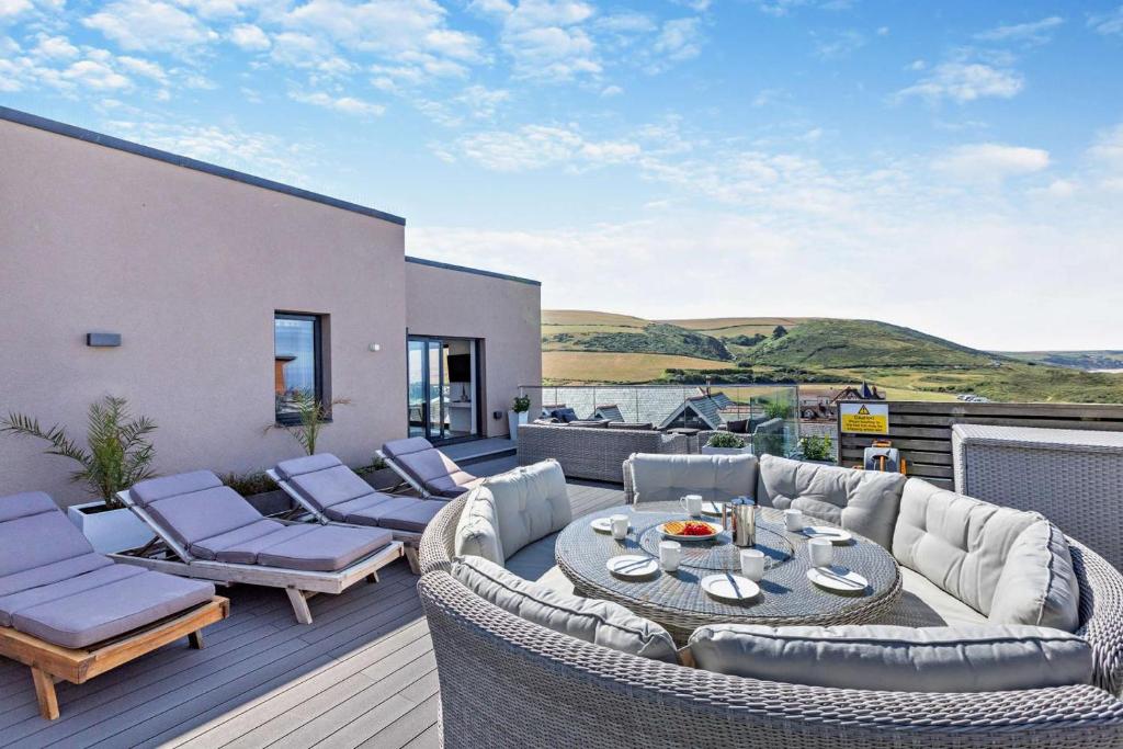 a patio with couches and a table and chairs at 3 Bed in Woolacombe oc-s29615 in Woolacombe
