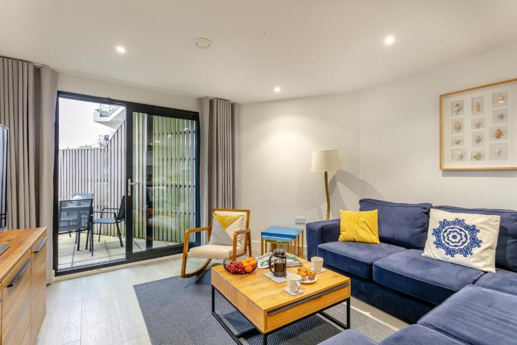 a living room with a blue couch and a table at 2 Bed in Woolacombe oc-c29617 in Woolacombe