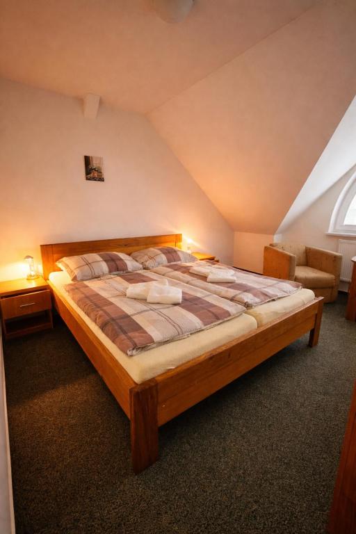 a bedroom with a large bed in a attic at REVIS Tachov in Tachov