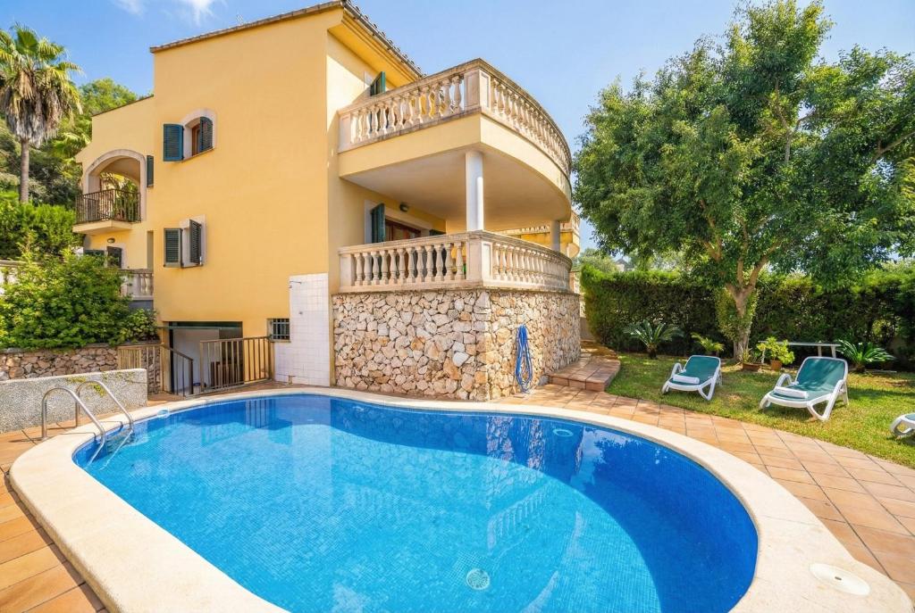 a villa with a swimming pool in front of a house at Ideal Property Mallorca - Can Besso in Alcanada
