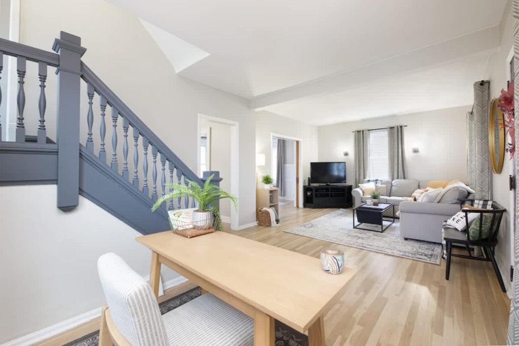a living room with a table and a couch at Walk to Highland Square, Sleeps 8 in Akron