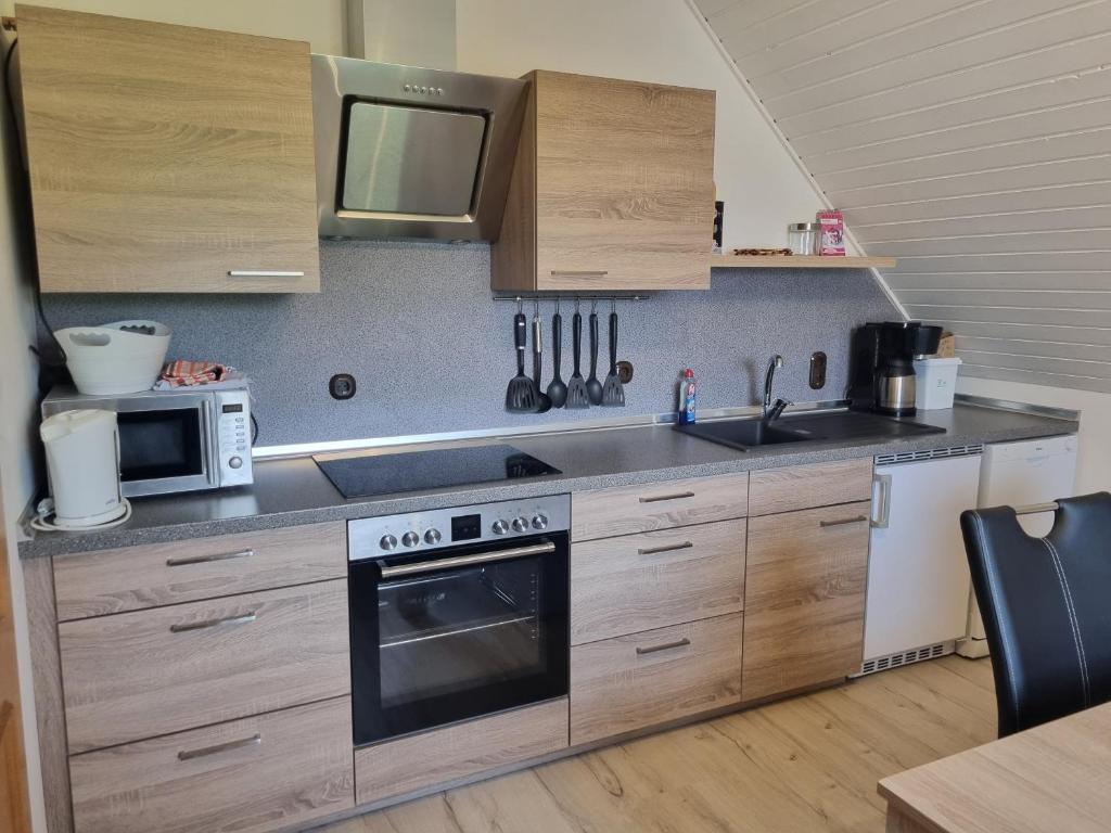 a kitchen with a stove and a microwave at Königsfeld in Königsfeld