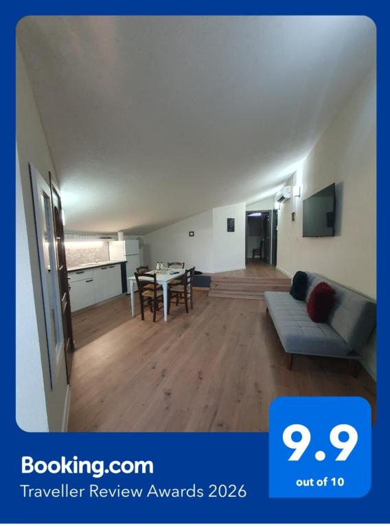 a living room with a couch and a table at MD Apartament- Cazare la curte in Curtea de Argeş
