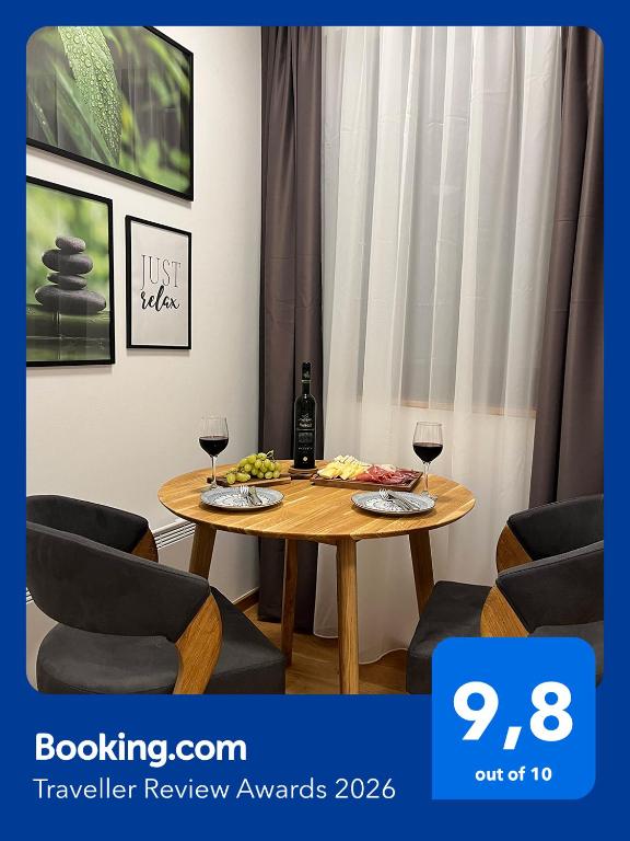a table with two glasses of wine in a room at Jahorina Apartment4Two in Jahorina