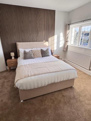 a bedroom with a large bed and a window at The Wrey Arms in Barnstaple