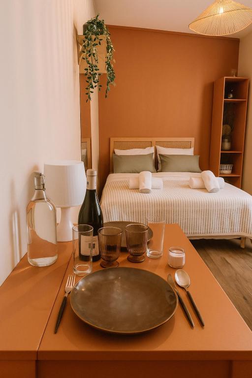 a table with a plate on a table with a bed at Charmant studio cosy - hypercentre Capitole in Toulouse