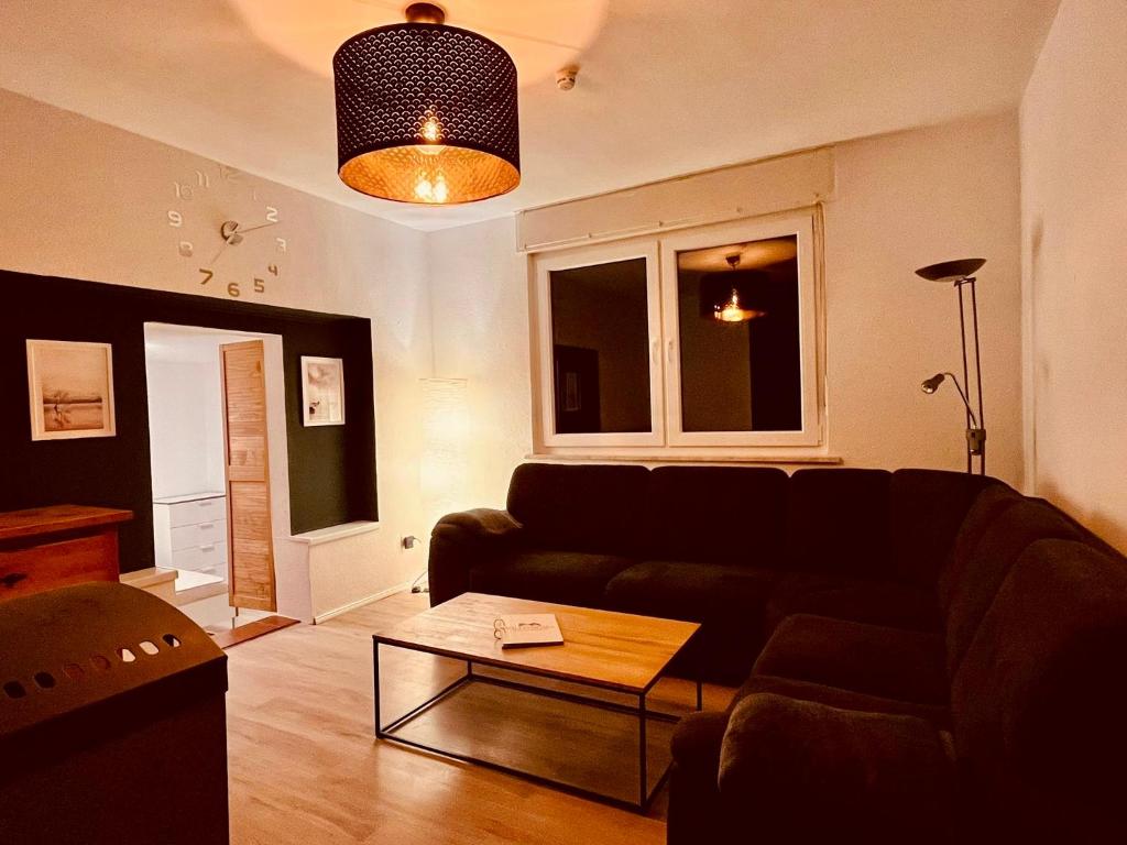 a living room with a couch and a coffee table at Ferienhaus am Bürgergarten in Bad Bentheim
