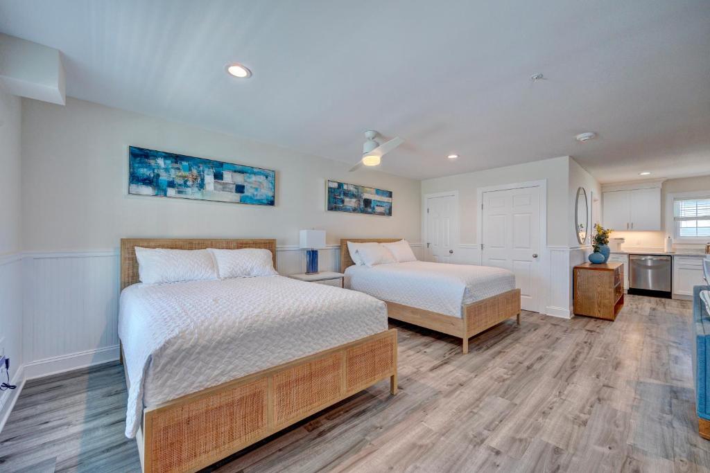 a bedroom with two beds and a kitchen at 2002 Queen Suite, 2nd Floor Surfside in Surf City