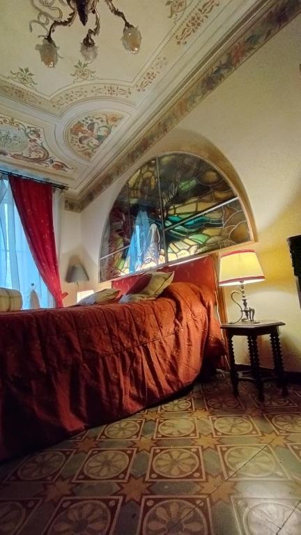 a bedroom with a large bed and a ceiling at DIMORA della TORRE a due passi dal mare in Sestri Levante