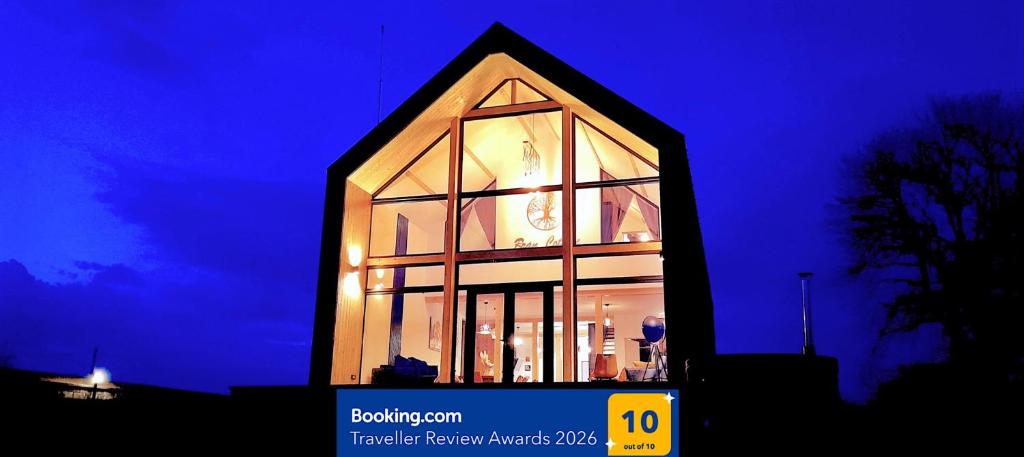 a building with a clock in the window at night at Bran Cottage in Bran