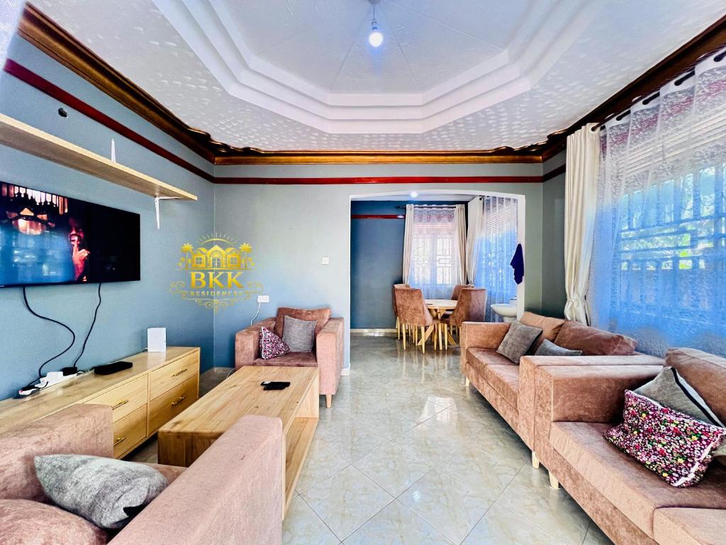 a large living room with couches and a tv at BKK Residences in Fort Portal