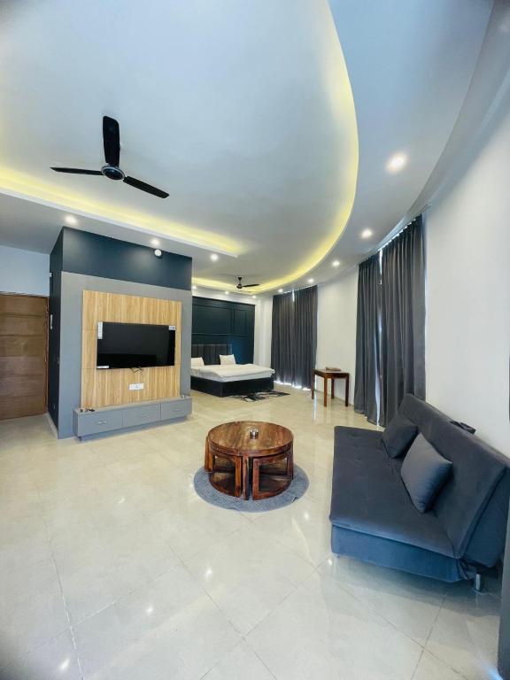 a living room with a couch and a table at Vantage View - Penthouse Apartment in Lucknow