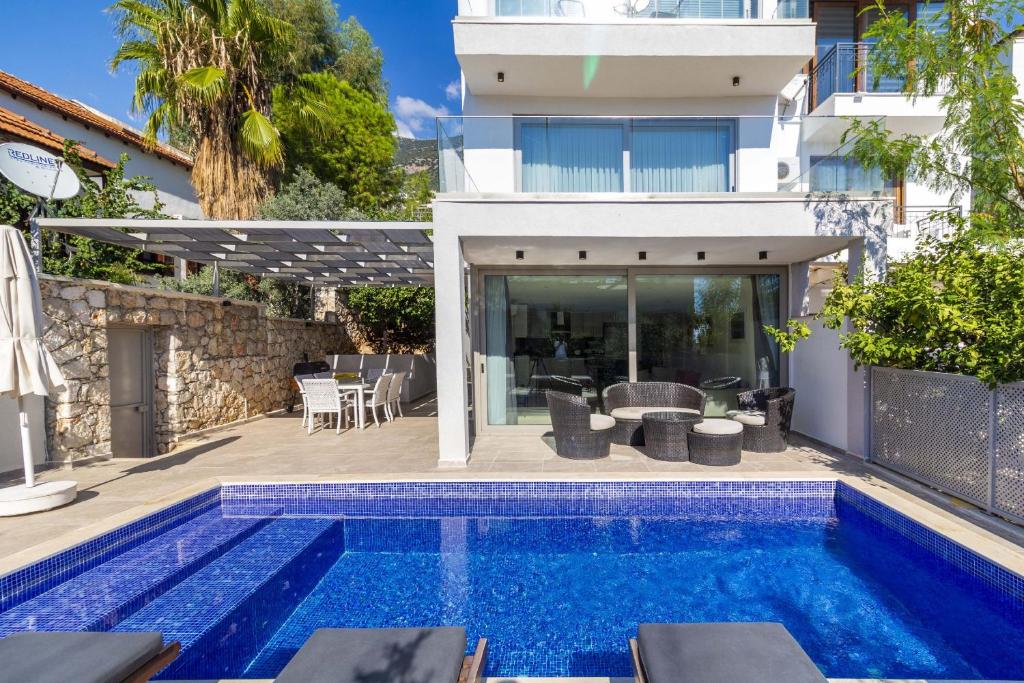 a villa with a swimming pool and a house at Villa Gunes in Kalkan