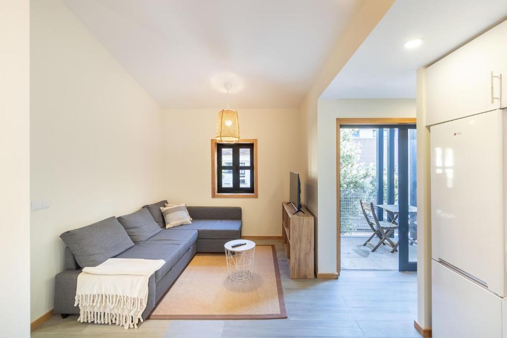 a living room with a couch and a table at Sunset Apartments in Ovar