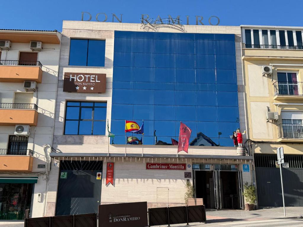 a hotel building with a blue facade on a street at HOTEL DON RAMIRO in Montilla