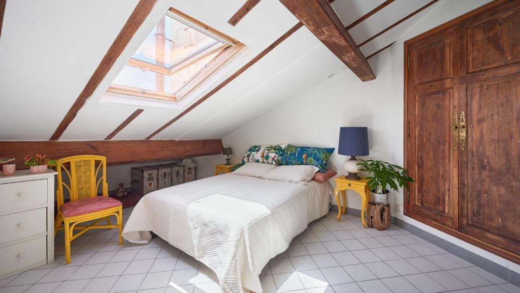 a bedroom with a bed and a skylight at Studio atypique de charme in Cannes