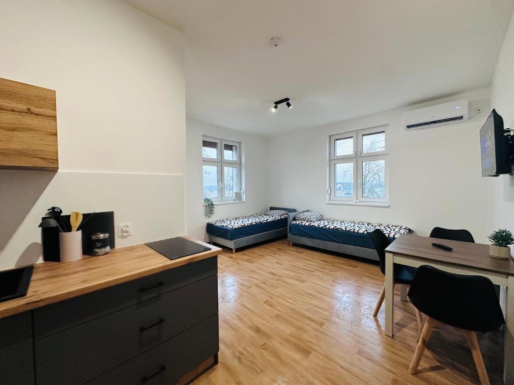 an apartment with a kitchen and a living room at Apartamenty przy Galerii in Kluczbork