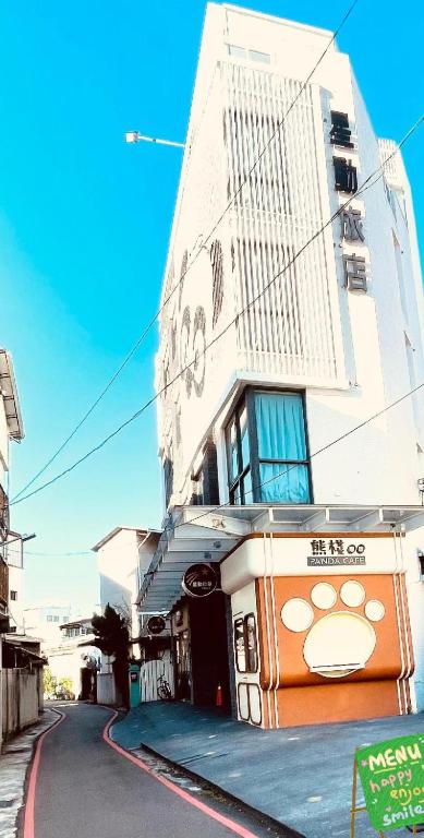 an orange bus parked in front of a building at Moving Star Hotel in Nan-tzu-ts'un