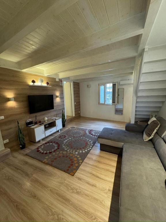 a living room with a couch and a flat screen tv at Il Maniero casa vacanze by MOH in Grottaglie