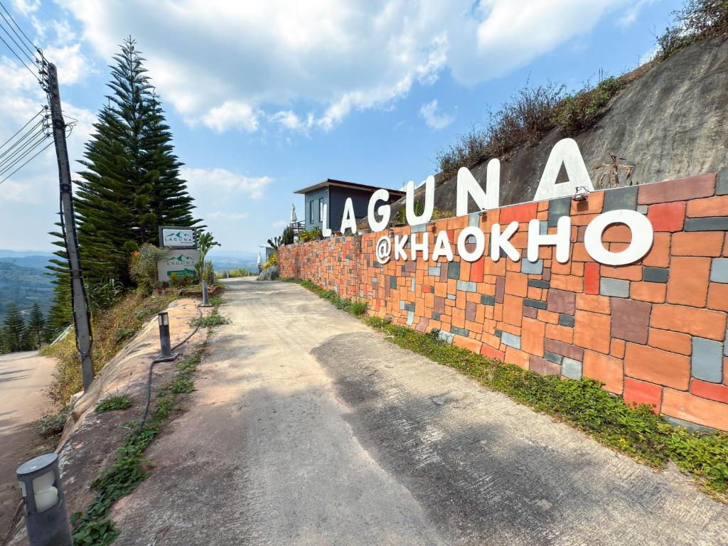 a road with a sign that reads akuna olympico at Laguna Khaokho in Khao Kho
