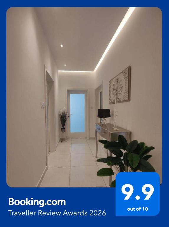 a hallway with a door and a room with a plant at Eivissa Apartment in Marsaskala