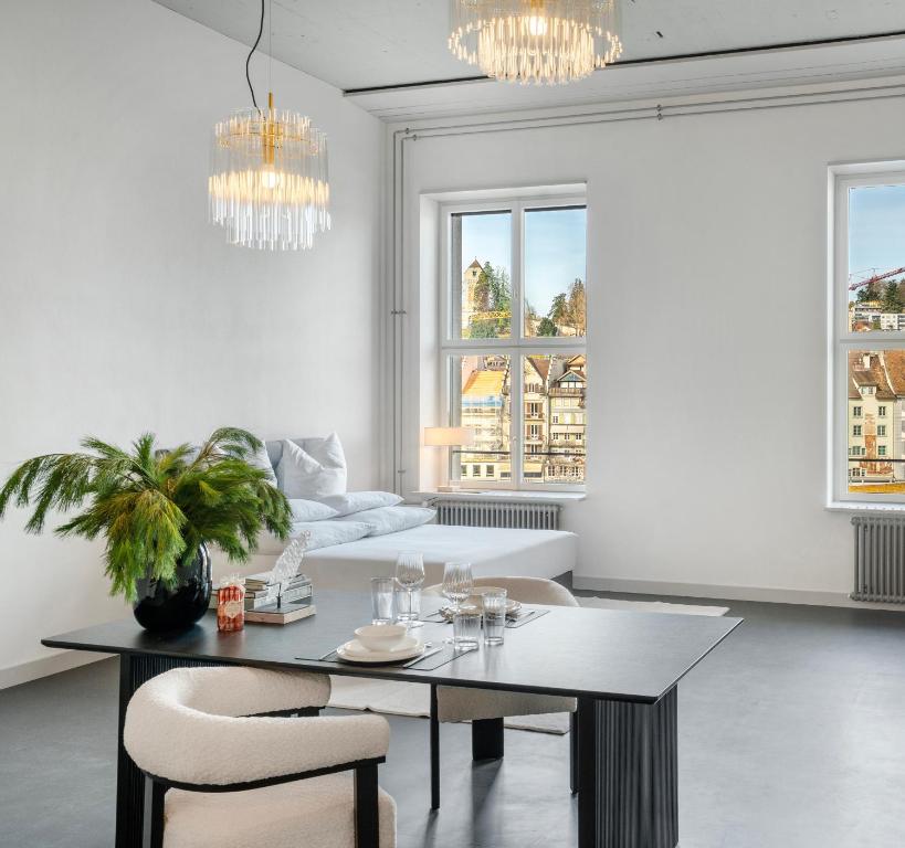 a living room with a table and a couch at Starlight Loft Lucerne, World Above Chapel Bridge in Lucerne