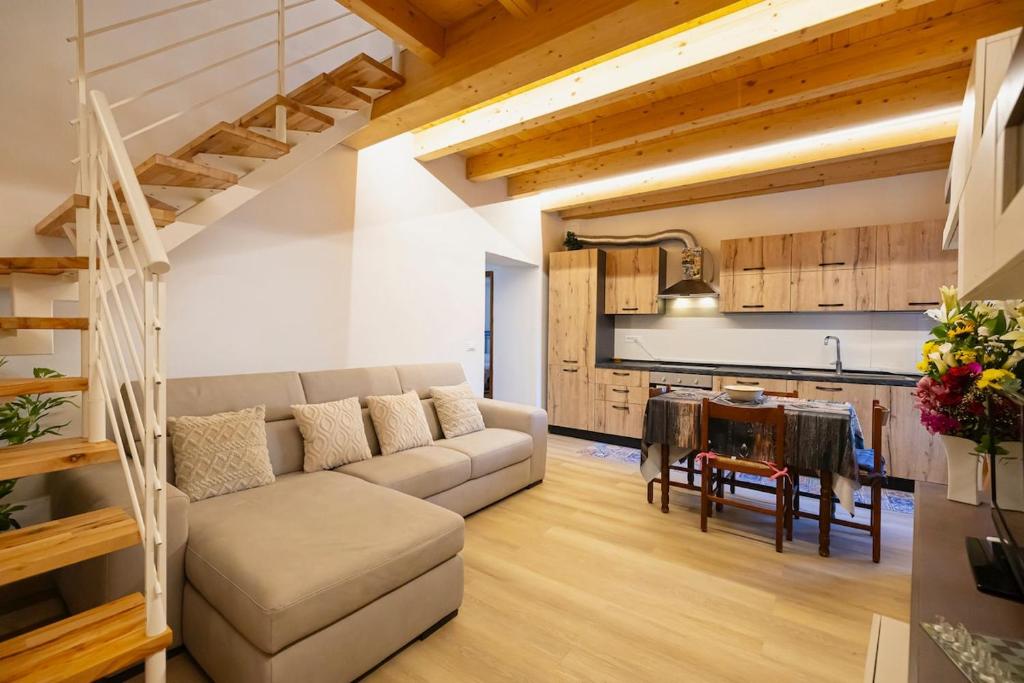 a living room with a couch and a table at La Casa della Musica by Le Case di Tati in Carpasio