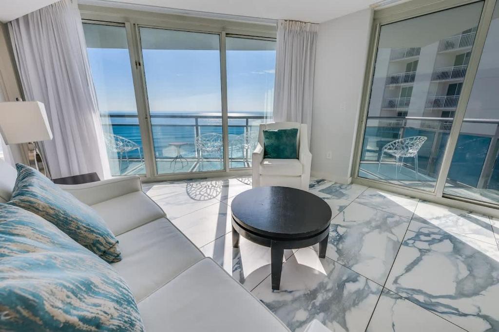 a living room with a couch and a table at Amazing Oceanfront 2BR condo with pools and views in Myrtle Beach