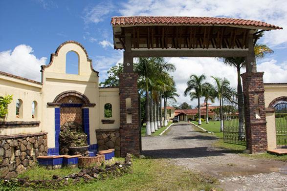un bâtiment avec une arche en briques à côté d'une rue dans l'établissement Costa del Llano Hotel Campestre, à Villavicencio