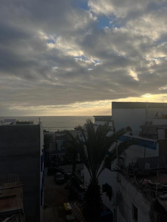 a view of a city with the ocean in the background at yallah surf house in Taghazout