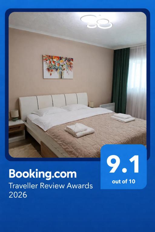 a bedroom with a bed in a room with avertisement at Apartament Serenity in Băile Herculane
