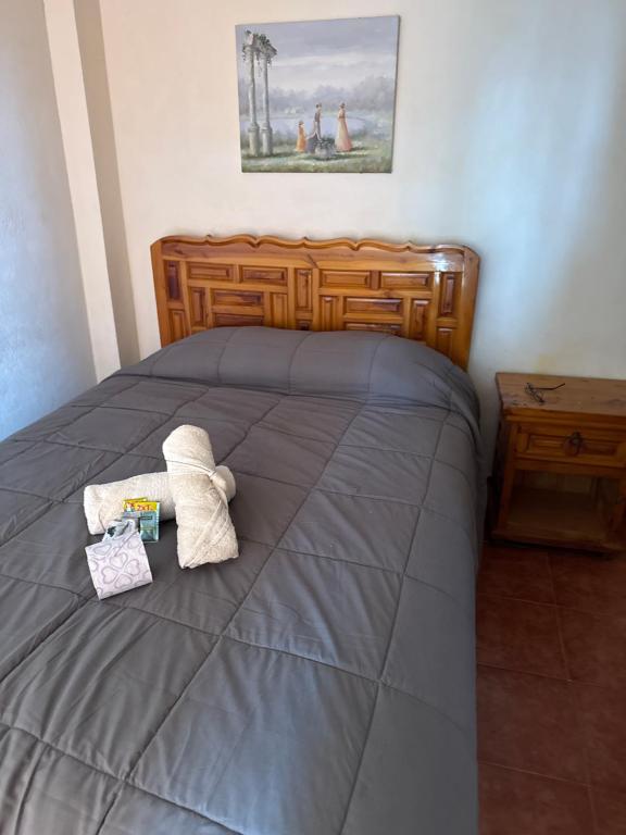a bedroom with a bed with two towels on it at Hotel LaLoma in San Miguel Regla