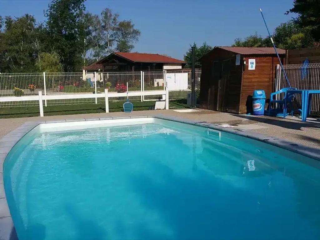 a large blue swimming pool in a yard at ZEcamping 3 étoiles familial pet friendly avec piscine et restaurant in Sandrans